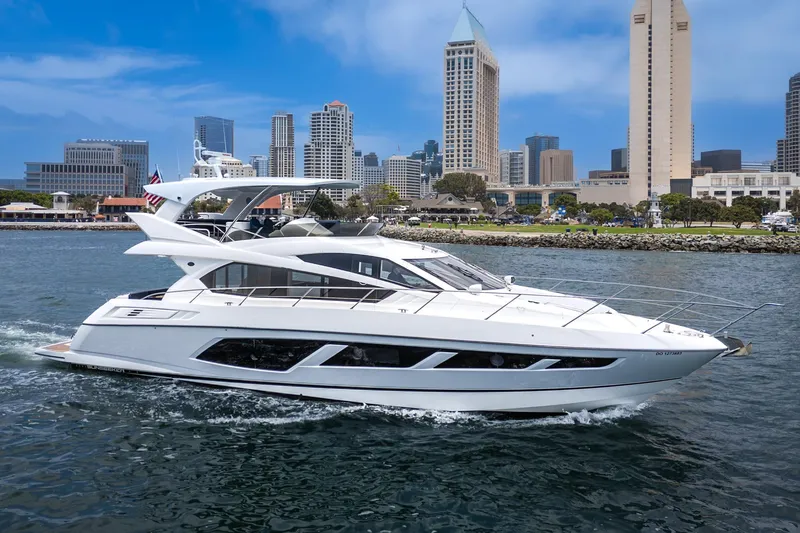 Slide: The Image of 2017 Sunseeker Manhattan 65 yacht cruising near city skyline. - 1