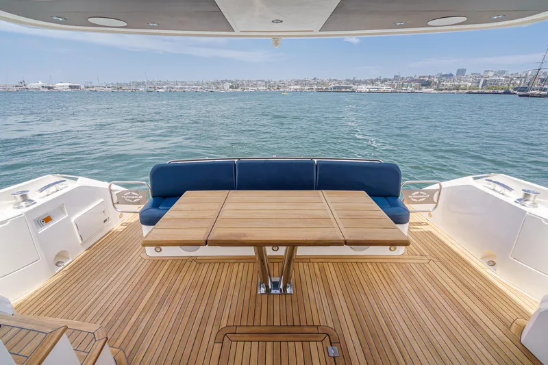 Slide: The Image of Luxury Sunseeker Manhattan 65 yacht deck with wooden table and blue seating, 2017 model. - 11