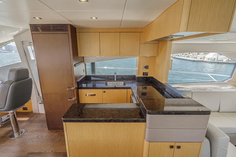 Slide: The Image of Luxurious 2017 Sunseeker Manhattan 65 yacht interior with modern kitchen and ocean view. - 19
