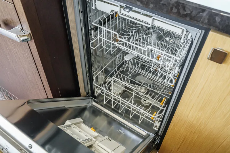 Slide: The Image of Open dishwasher in Sunseeker Manhattan 65 yacht, 2017 model, showcasing interior racks. - 23