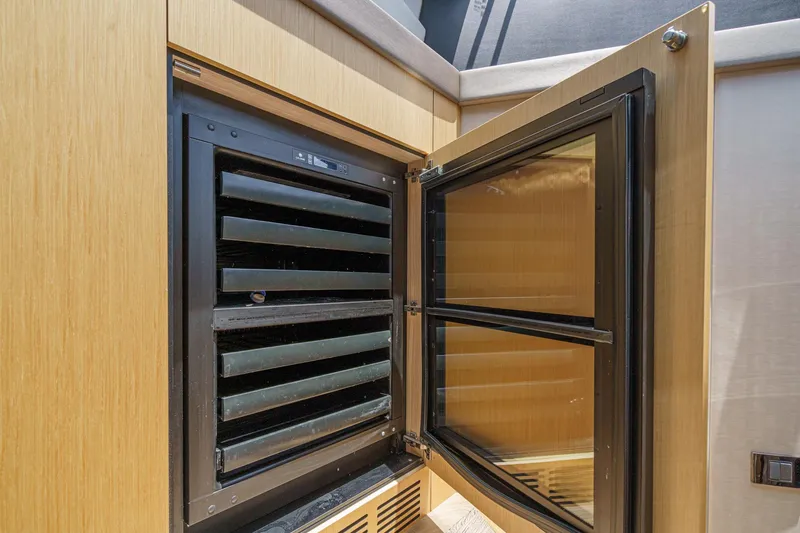 Slide: The Image of Open cabinet with black interior on 2017 Sunseeker Manhattan 65 yacht. - 24