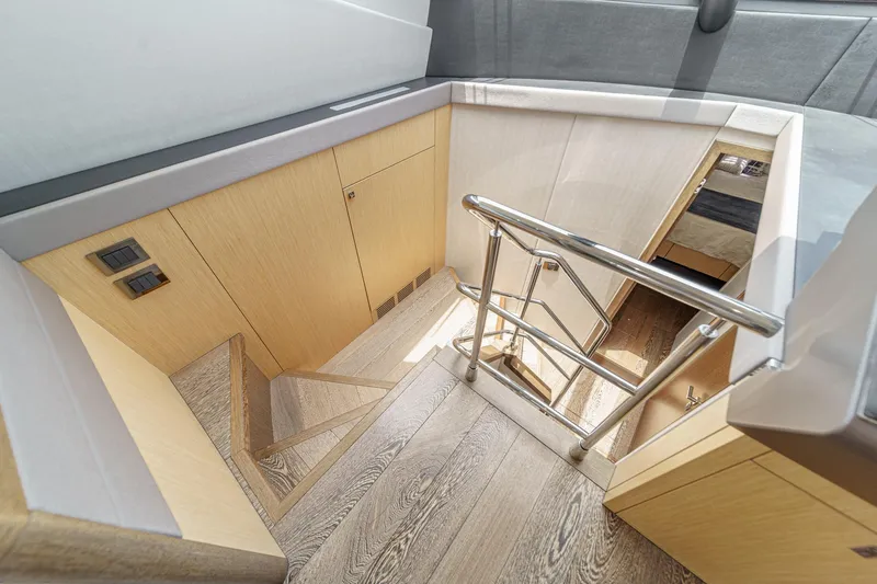 Slide: The Image of Staircase in 2017 Sunseeker Manhattan 65 yacht with sleek wooden finish and metal railing. - 31