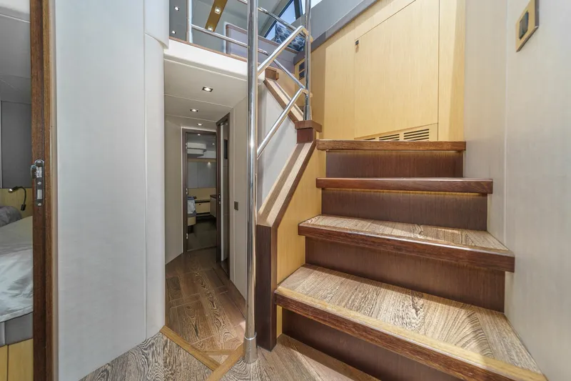 Slide: The Image of Interior of 2017 Sunseeker Manhattan 65 yacht, featuring elegant wooden stairs and modern design. - 32