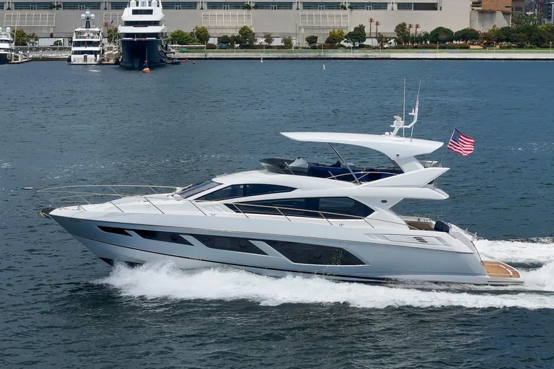 Slide: The Image of 2017 Sunseeker Manhattan 65 yacht cruising on water with American flag. - 4
