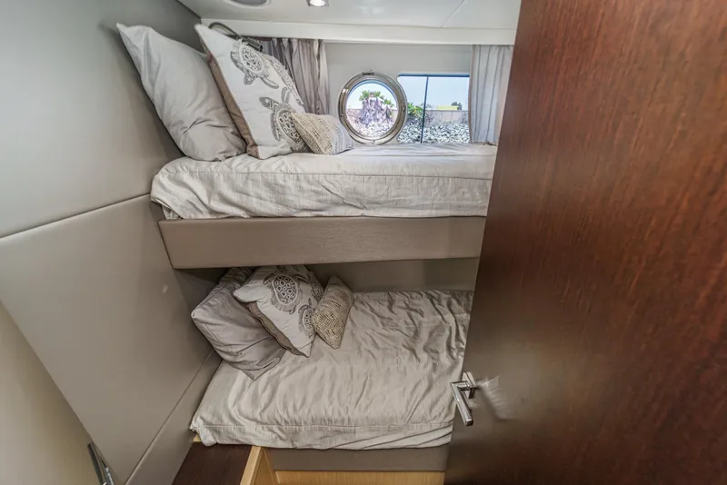Slide: The Image of Bunk beds in 2017 Sunseeker Manhattan 65 yacht cabin with porthole view. - 44