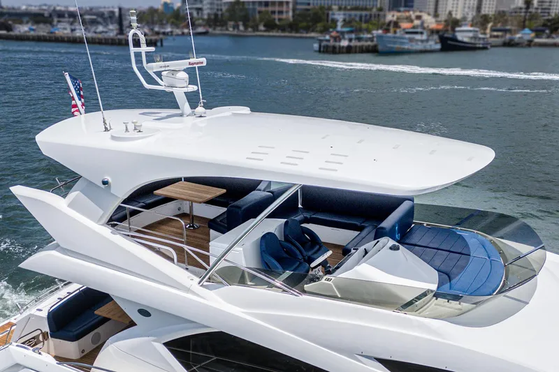 Slide: The Image of Luxurious 2017 Sunseeker Manhattan 65 yacht cruising in a scenic harbor. - 45