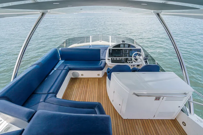 Slide: The Image of Luxurious 2017 Sunseeker Manhattan 65 yacht interior with blue seating and modern helm. - 47