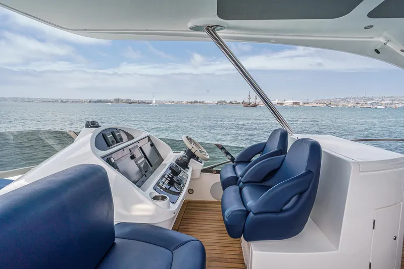 Slide: The Image of Luxurious 2017 Sunseeker Manhattan 65 yacht helm with blue seating and ocean view. - 48