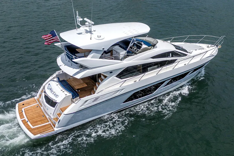 Slide: The Image of 2017 Sunseeker Manhattan 65 yacht cruising on open water, rear view. - 7