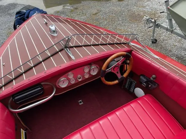 Slide: The Image of Vintage Alsberg Brothers 17 boat interior, red upholstery, wooden dashboard, classic steering wheel, 2002 model. - 10