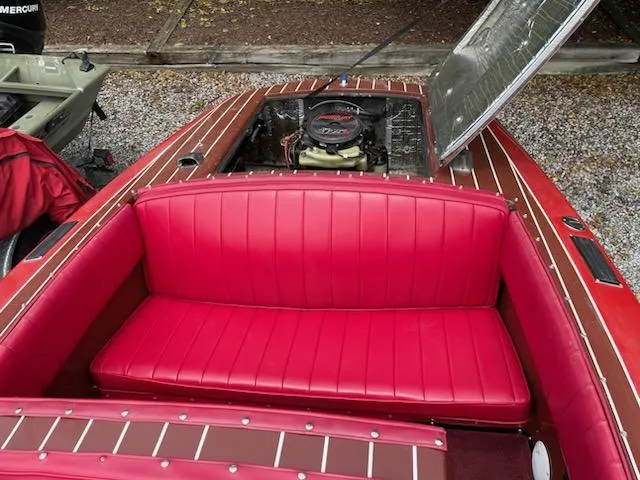Slide: The Image of Red leather interior of a 2002 Alsberg Brothers Model 17 boat with open engine compartment. - 12