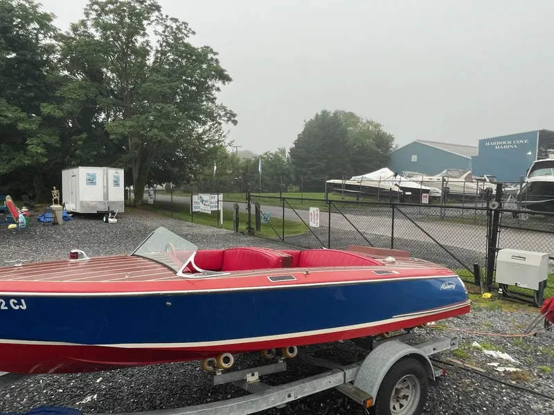 Slide: The Image of Red and blue Alsberg Brothers 17 boat on trailer at marina, 2002 model. - 16