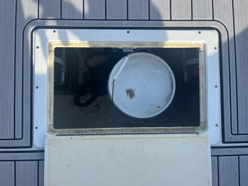 Slide: The Image of Storage compartment on 1971 Aquasport 222 boat with a white bucket inside. - 14