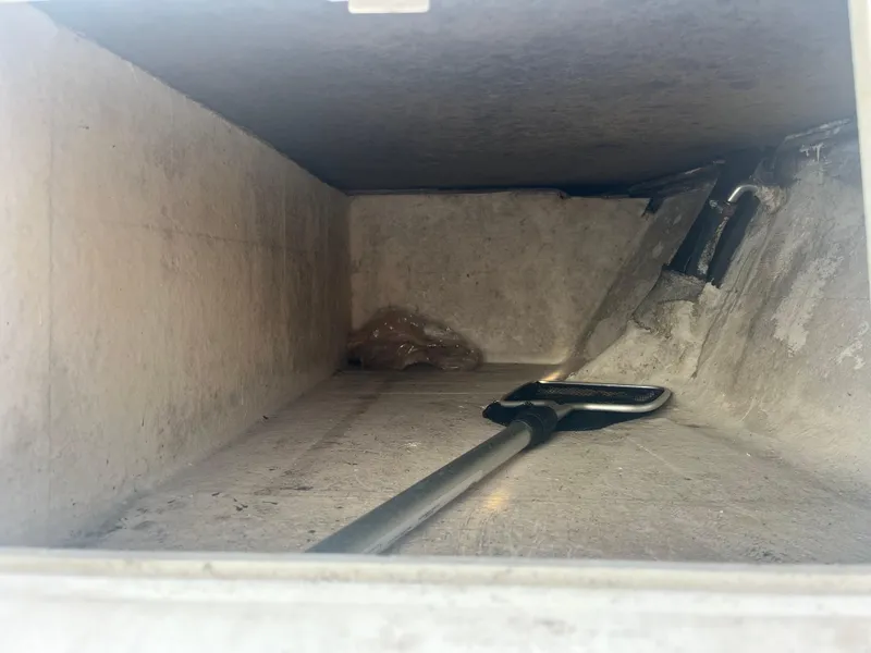 Slide: The Image of Interior compartment of a 1971 Aquasport 222 boat, featuring a net tool. - 19