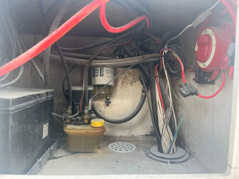 Slide: The Image of 1971 Aquasport 222 boat wiring and battery compartment with cables and switches. - 22