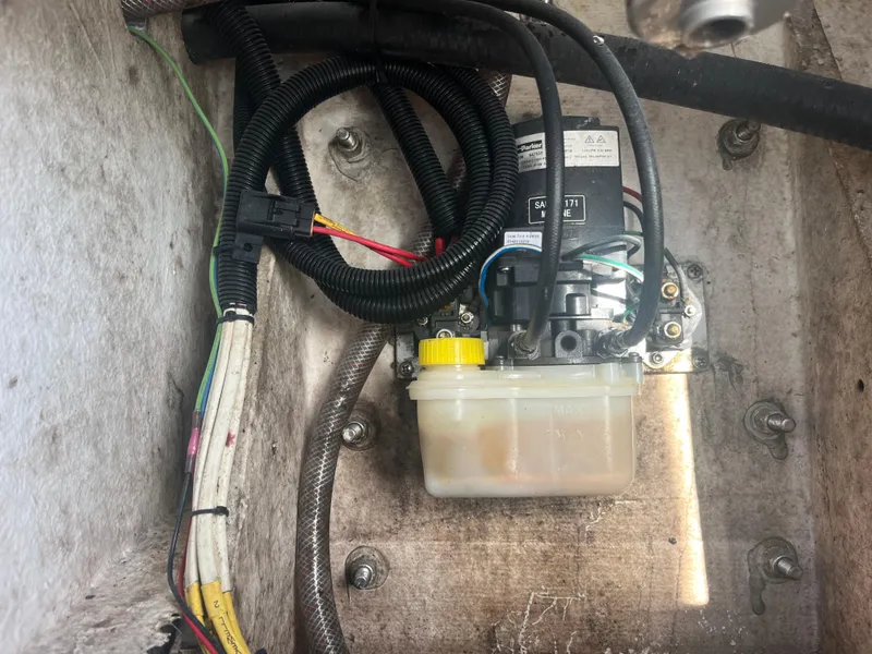 Slide: The Image of 1971 Aquasport 222 boat engine compartment with wiring and fluid reservoir. - 24