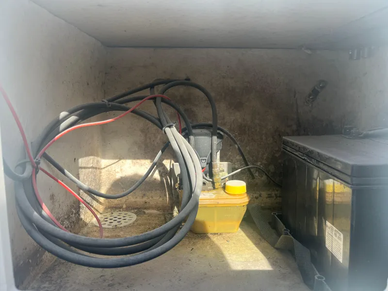 Slide: The Image of 1971 Aquasport 222 boat compartment with cables, battery, and pump. - 25