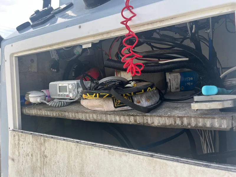 Slide: The Image of Storage compartment of a 1971 Aquasport 222 boat with various equipment and cables. - 26
