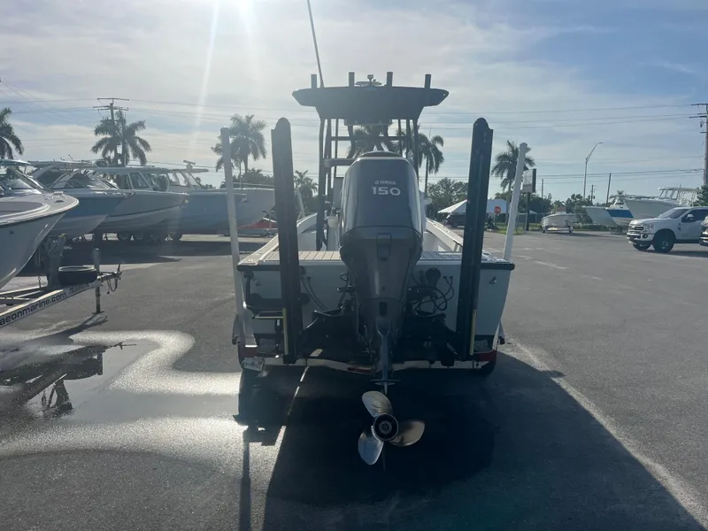 Slide: The Image of 1971 Aquasport 222 boat with Yamaha 150 engine in a sunny marina. - 3