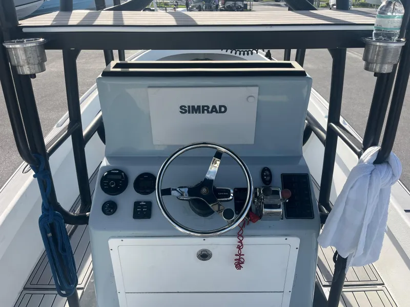Slide: The Image of 1971 Aquasport 222 boat console with Simrad navigation system and steering wheel. - 6
