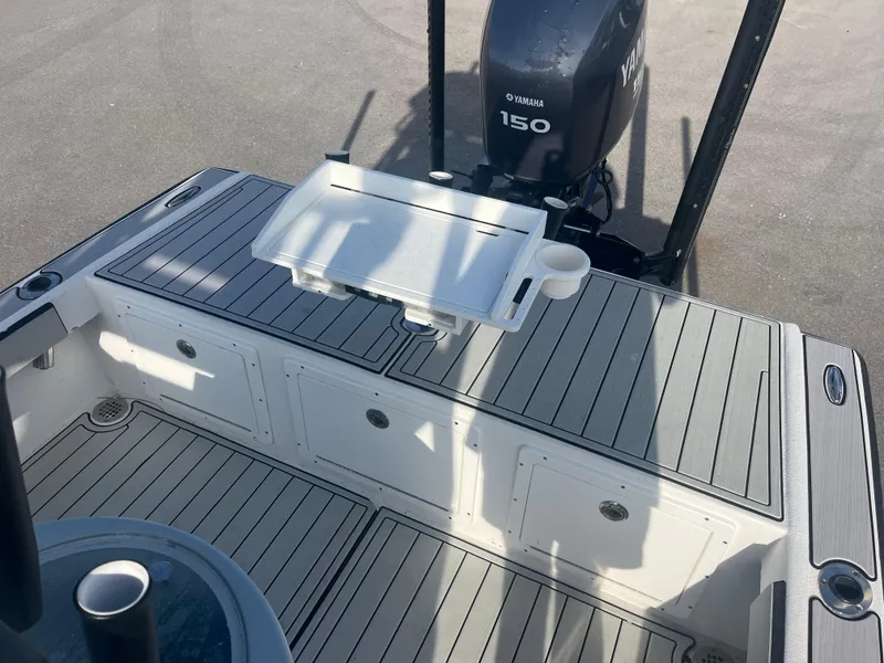 Slide: The Image of 1971 Aquasport 222 boat deck with Yamaha 150 outboard motor, featuring a cutting board and cup holder. - 8