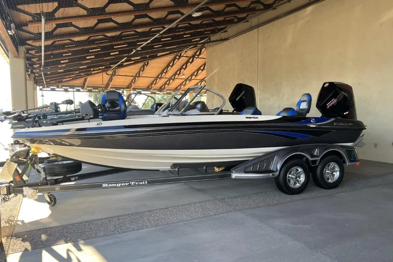 The Image of 2025 Ranger 212LS boat on trailer, under a covered structure. - 0