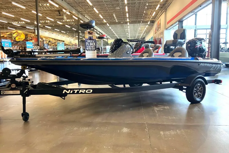 The Image of A 2025 Nitro Z17 boat is displayed in a showroom. It features a blue hull and modern seating. - 0