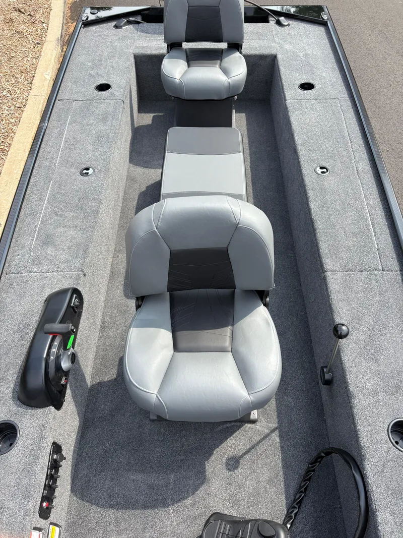 Slide: The Image of 2025 Tracker Panfish 17 boat interior with gray seating and control panel. - 2