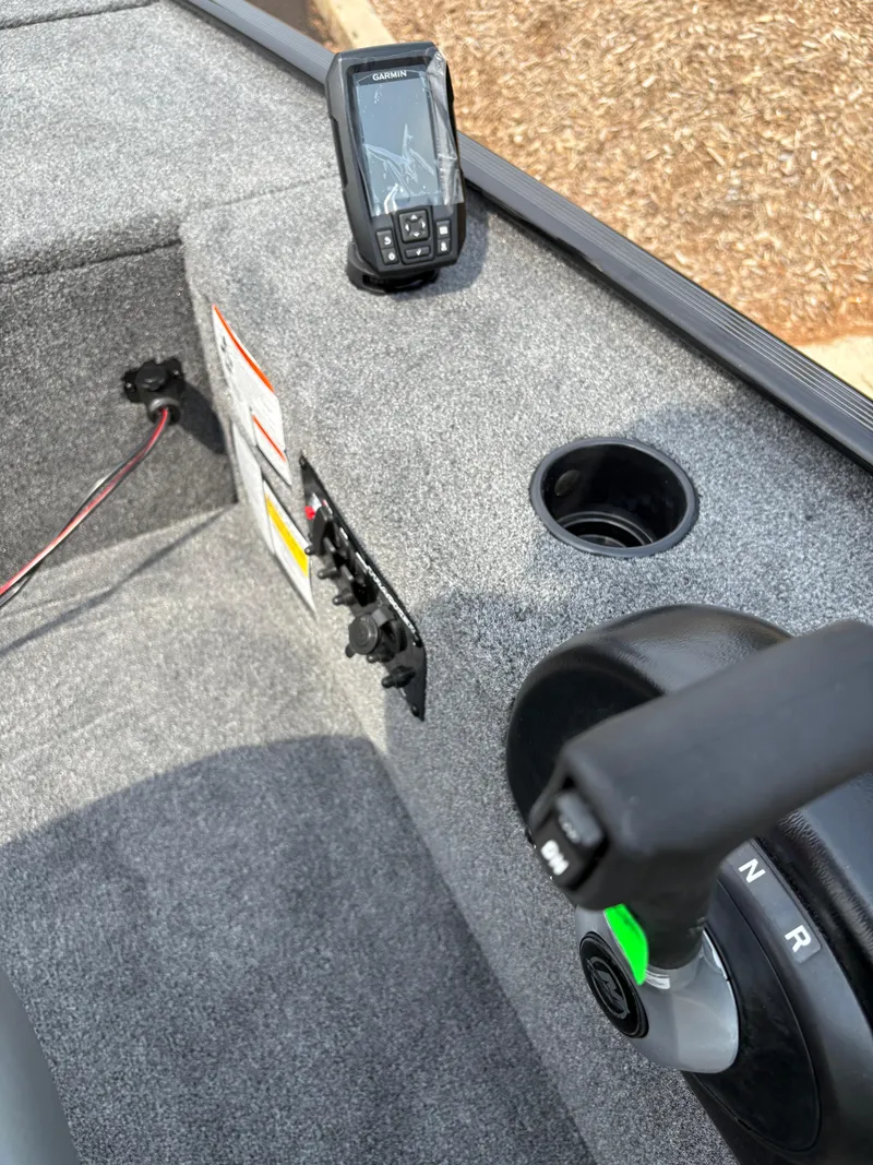 Slide: The Image of 2025 Tracker Panfish 17 boat interior with control panel and fish finder. - 3