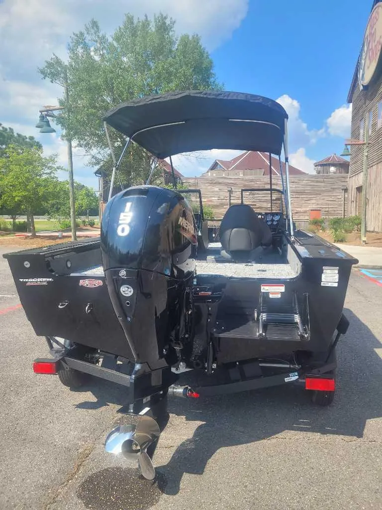 Slide: The Image of 2025 Tracker Targa V-18 WT boat with Mercury 150 engine, parked outdoors. - 5