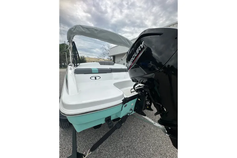 Slide: The Image of 2025 Tahoe T16 boat with Mercury engine, parked outdoors under cloudy sky. - 3