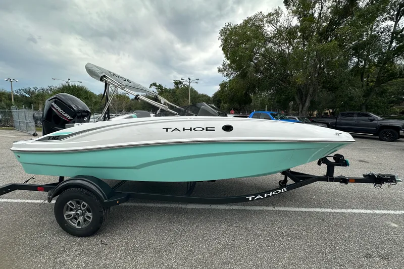 The Image of 2025 Tahoe T16 boat on trailer, featuring sleek design and Mercury engine. - 0
