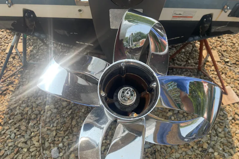 Slide: The Image of Close-up of a shiny boat propeller on a 2015 Pursuit DC 265 Dual Console. - 12