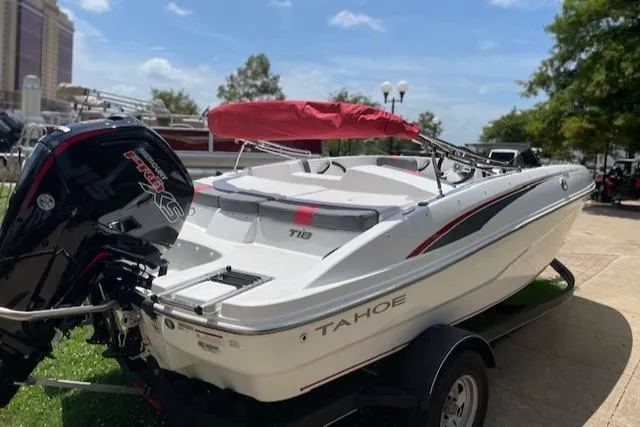 Slide: The Image of 2024 Tahoe T18 boat with red canopy and powerful outboard motor on trailer. - 5