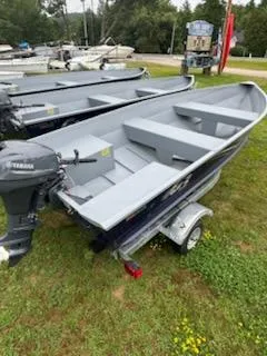 Slide: The Image of 2025 G3 Guide V12 boat on trailer with Yamaha motor, parked on grass. - 11