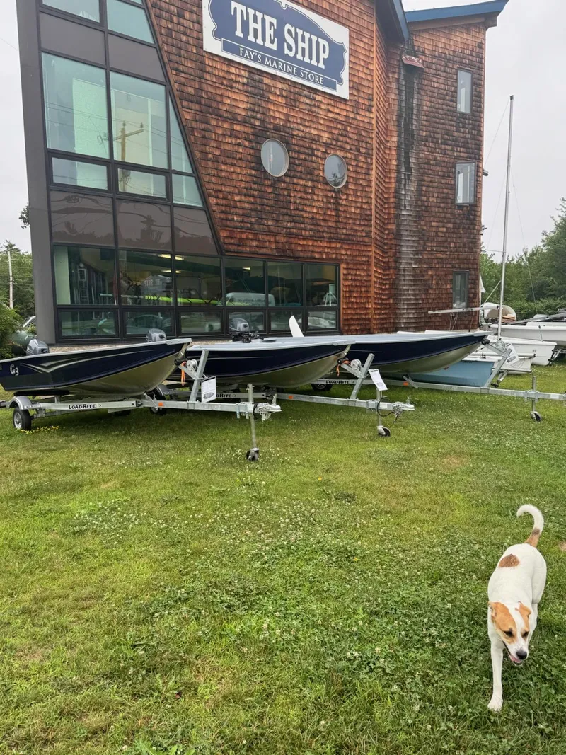 Slide: The Image of Boats outside Fay's Marine Store with a dog on the grass, featuring G3 Guide V12, 2025 model. - 2