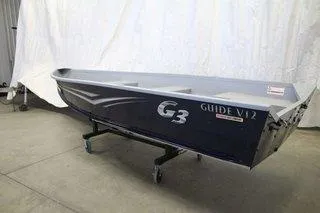Slide: The Image of 2025 G3 Guide V12 boat displayed indoors on a wheeled stand. - 4