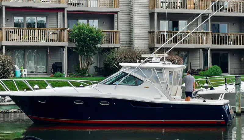 Slide: The Image of 2005 Tiara Yachts 3600 Open docked in a marina under clear blue skies. - 0