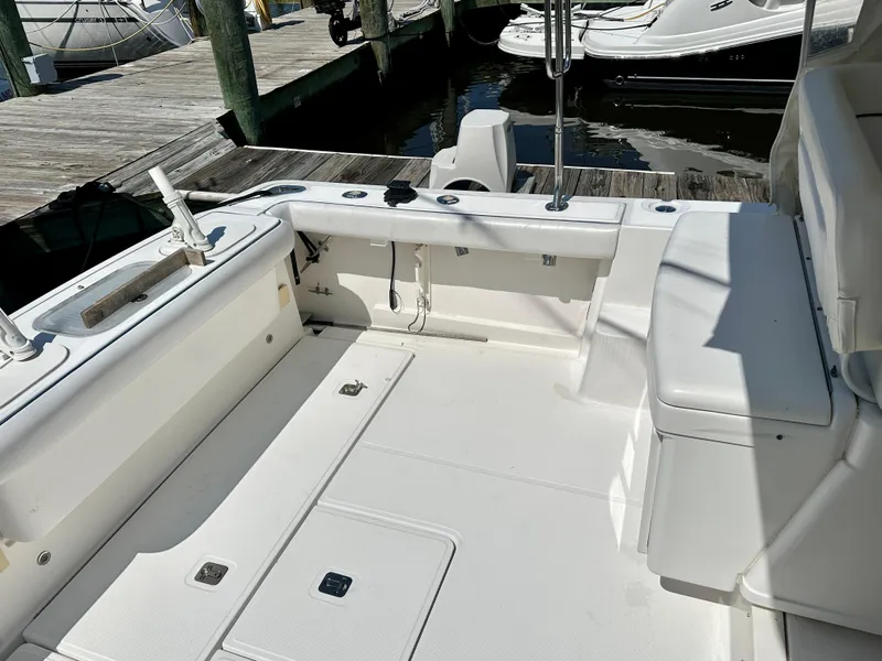 Slide: The Image of 2005 Tiara Yachts 3600 Open boat deck with fishing setup and storage compartments. - 10