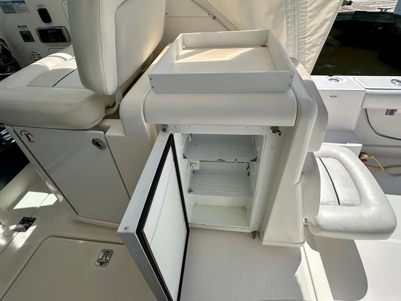 Slide: The Image of 2005 Tiara Yachts 3600 Open interior with white seating and helm area. - 13