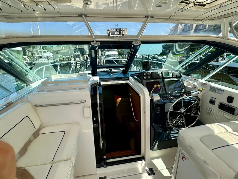 Slide: The Image of 2005 Tiara Yachts 3600 Open interior with white seating and fishing rod holders. - 15