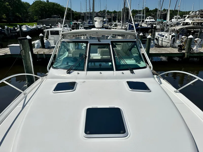Slide: The Image of Bow of 2005 Tiara Yachts 3600 Open, featuring anchor and railing, docked on calm water. - 20