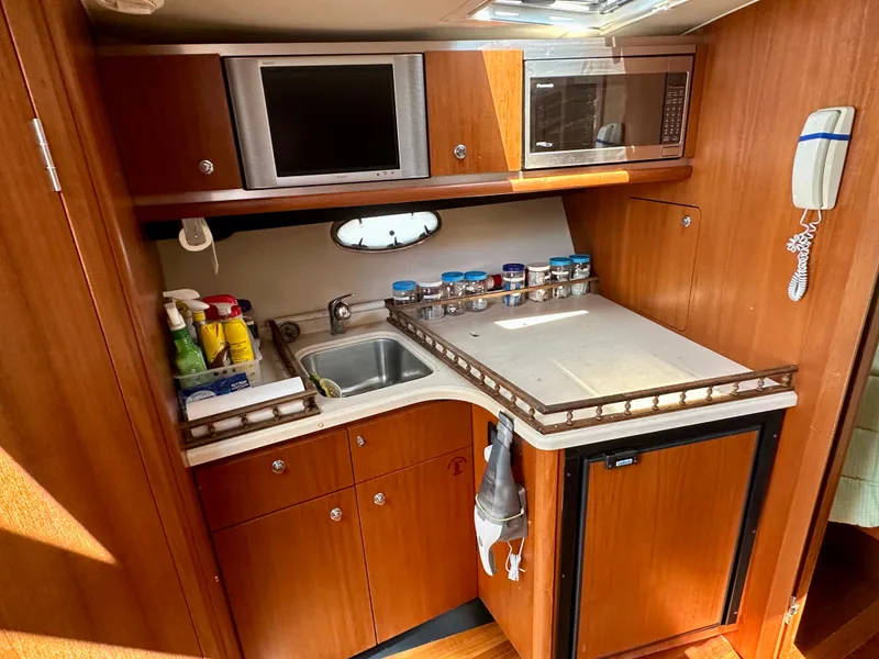 Slide: The Image of 2005 Tiara Yachts 3600 Open interior with cream seating and wooden table. - 23