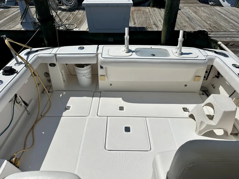 Slide: The Image of 2005 Tiara Yachts 3600 Open boat deck with fishing rod holders and storage compartments. - 9