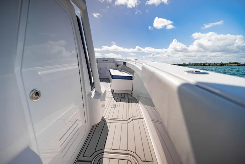 Slide: The Image of 2026 Reef Runner 340 boat deck with sleek design, under a bright blue sky. - 15