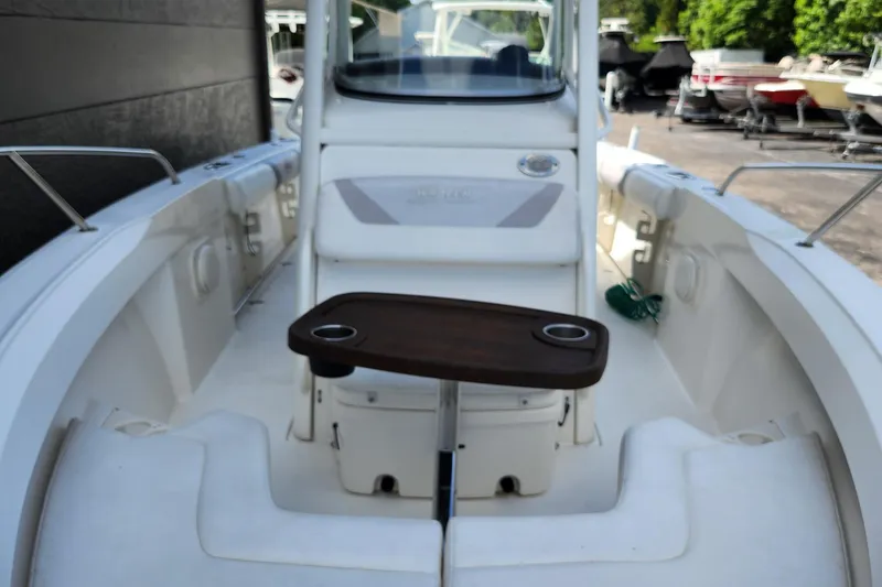 Slide: The Image of 2014 Boston Whaler 250 Outrage boat interior with seating and table. - 11
