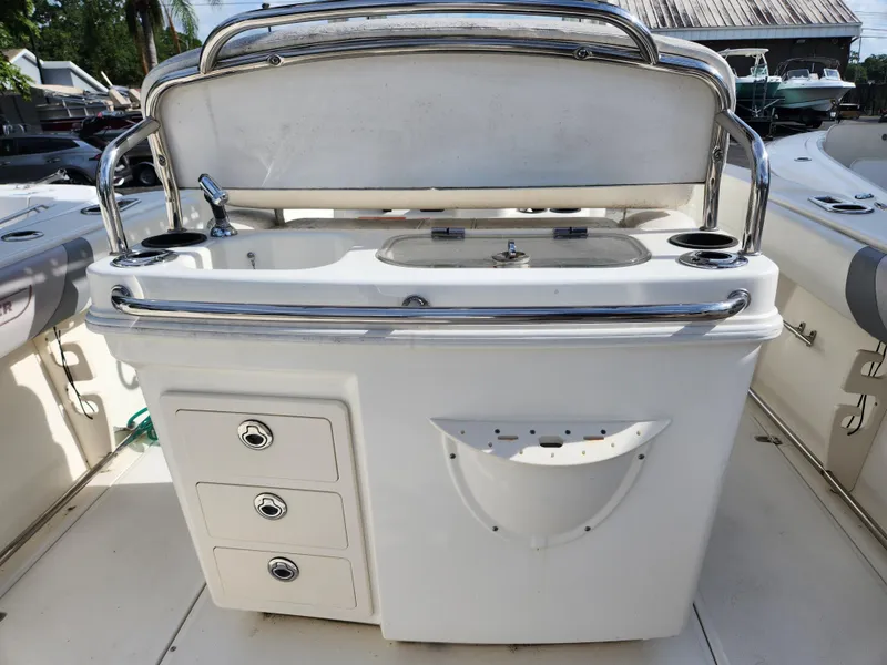 Slide: The Image of 2014 Boston Whaler 250 Outrage boat interior with storage and sink. - 6