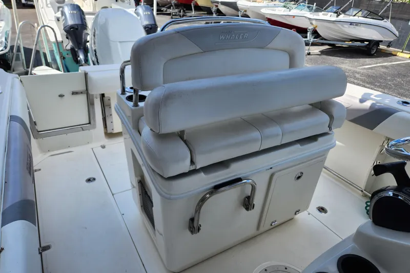Slide: The Image of 2014 Boston Whaler 250 Outrage boat interior with seating and storage. - 8