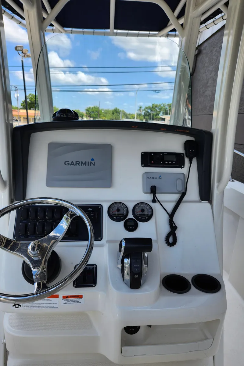 Slide: The Image of 2014 Boston Whaler 250 Outrage helm with Garmin navigation system and steering wheel. - 9