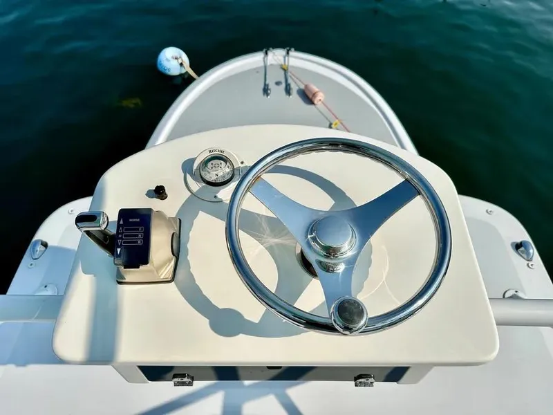 Slide: The Image of Steering wheel of 2008 Buddy Cannady 28 Custom Express boat on calm water. - 10